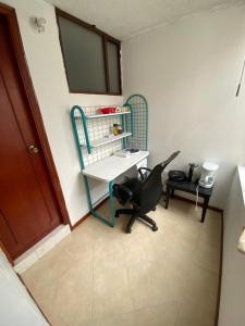 een kantoor met een bureau en een stoel in een kamer bij ERY total confort Pasto apto in Pasto