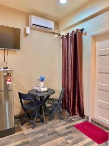 a small kitchen with a table and a refrigerator at Resting View in Male City