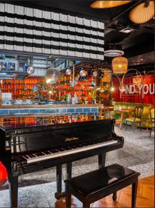 a piano sitting in a room with a restaurant at Anjeliq Downtown Boutique Hotel in Alanya