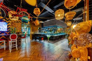 a restaurant with a large teddy bear and a bar at Anjeliq Downtown Boutique Hotel in Alanya +36 photos