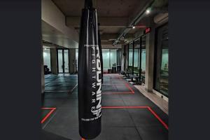 a large black sign in a room with windows at Studio4 in the heart of the city in Denpasar