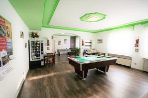 a large room with a pool table in it at Appartements Biedermeier in Bad Krozingen
