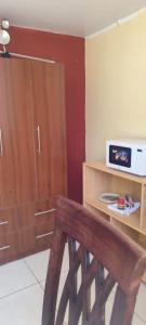 a kitchen with a wooden cabinet and a wooden bench at Casa particular in Arequipa