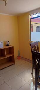 a empty room with a chair and a window at Casa particular in Arequipa