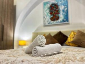 a pair of towels sitting on a bed at Heart of Valletta - Apartment in Valletta