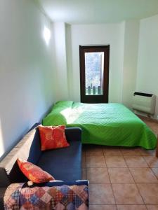 a bedroom with a bed and a couch in it at Lorica Apartment Residence LagoSila in Lorica
