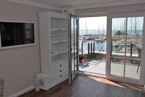a living room with a view of a marina at HafenResidenz Fehmarn in Lemkenhafen auf Fehmarn