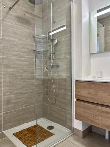 a shower with a glass door in a bathroom at Appartement Valmeinier centre - Le Céleste in Valmeinier