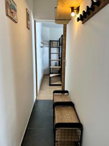 a hallway with two benches in a room at Appartement Valmeinier centre - Le Céleste in Valmeinier