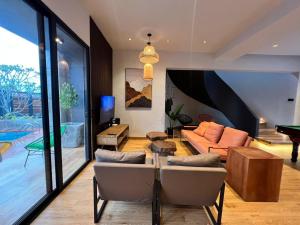 a living room with a couch and a table at LA Villas Kuantan Private Pool,Near Beach,BBQ,Karaoke in Kuantan