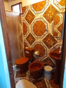 a bathroom with two toilets and a tiled wall at Posada Portal del Iguazu in Puerto Iguazú