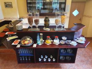a bar with glasses and plates of food and drinks at Pension Villa Anna in Bad Schandau