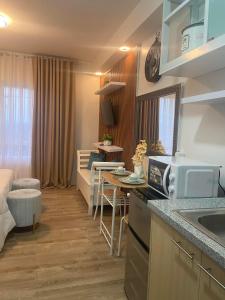 a kitchen and living room of a apartment at Jeiden Suites Bacolod in Bacolod
