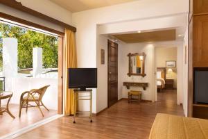 A television and/or entertainment centre at Ramada Loutraki Poseidon Resort