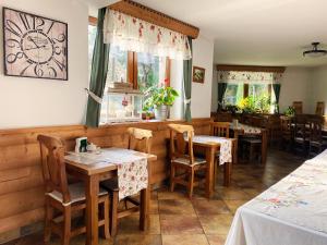 a restaurant with tables and chairs in a room at Pod Lipą 2 in Białka Tatrzańska