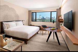 a hotel room with a bed and a large window at BEI Zhaolong Hotel, part of JdV by Hyatt in Beijing