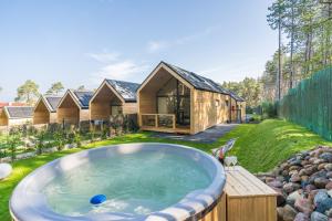a home with a hot tub in the yard at Bursztynowo in Kąty Rybackie
