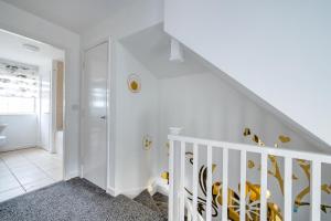 a white staircase in a home with white walls at *RC27R* For your relaxed & Cosy stay + Parking in Kirkstall