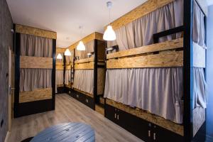 a large room with bunk beds with curtains at Hostel Day 'N' Night in Niš