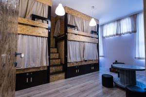 a room with two bunk beds and a table at Hostel Day 'N' Night in Niš
