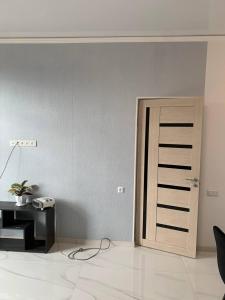 a room with a door with a desk and a phone at Agarak House 