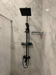 a shower with a laptop on a rack in a bathroom at Agarak House 