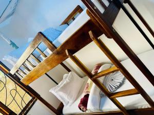 a ladder bunk bed with shoes on it at Sophie Homestay in Moshi