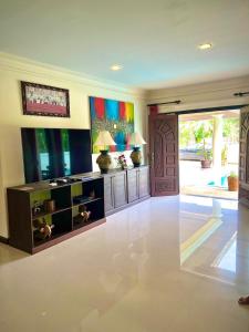 a large living room with a large entry door at Grand Villa Khaolak in Khao Lak