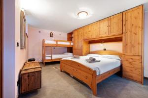 a bedroom with a bed and a bunk bed at Baita Margherita in Casargo
