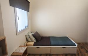 a small bedroom with a bed with a window at Apartamento Mouzinho in Horta