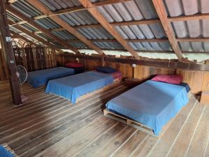 an attic bedroom with two beds and a roof at Dragonfly Guesthouse in Koh Rong Sanloem