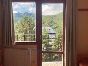a window with a view of a mountain view at Apartamentos Midi 3000 in Formigal