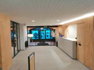 a hallway of a building with a lobby with a desk at Apartamentos Midi 3000 in Formigal