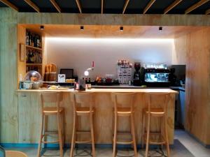 a kitchen with a bar with stools around it at Apartamentos Midi 3000 in Formigal