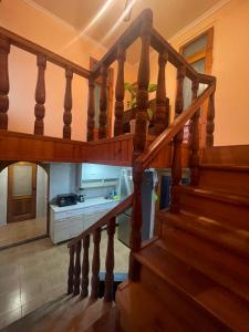 a staircase in a house with a kitchen in the background at Мир in Ochamchira