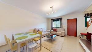 een woonkamer met een tafel en een bank bij Quiet and Sunny apartment with swimming pool in Ciudad Quesada