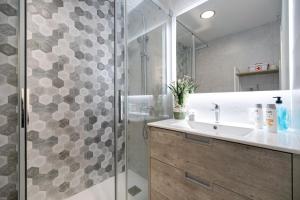 un baño con ducha y lavabo en Refugio del mar, en El Puerto de Santa María 27 fotos más