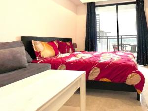 a living room with a bed and a couch at Prince Golden Bay Sihanoukville in Sihanoukville +32 photos