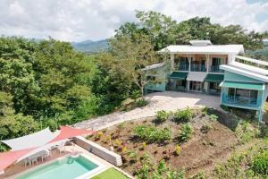 an aerial view of a house with a swimming pool at Boutique Tropical Retreat, Sleeps 10, Perfect for Friends and Fams in Sámara