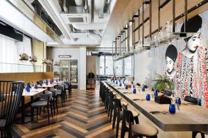 a dining room with long tables and chairs at Aloft Tokyo Ginza in Tokyo