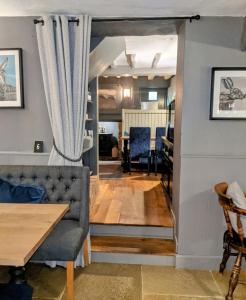a living room with a couch and a table at The Keepers Arms in Quenington