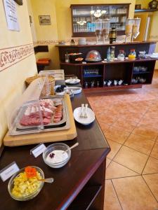 a buffet line with food on a counter in a restaurant at Hotel Garni Dekorahaus in Bad Schandau