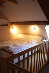 a bed in a room with lights on it at Ferienhof Spiegelhaus in Krummhörn