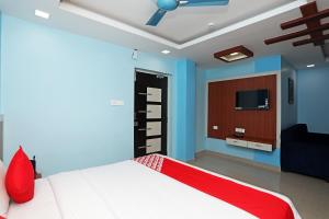 a bedroom with a bed and a tv in it at Sai Swastik in Bhubaneshwar