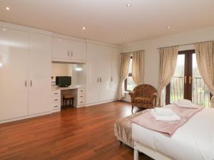 a bedroom with a bed and a desk and a television at The House at The Sitwell Arms in Sheffield