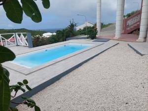 a swimming pool in the middle of a walkway next to a house at Sea-Renity in Oyster Pond