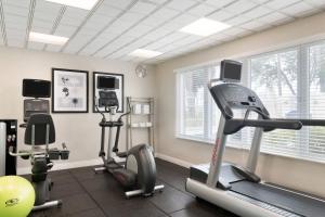 a gym with two treadmills and two exercise bikes at TownePlace Suites Boca Raton in Boca Raton