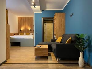 a living room with a couch and a bed at 1320 Apartments in Sibiu