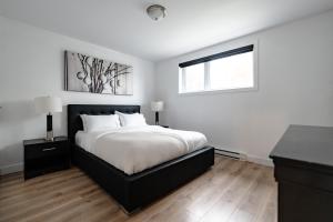 a bedroom with a large bed and a window at Denis in Quebec City