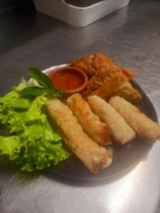 a plate of food with french fries and lettuce at FASTHOTEL Le Costabonne in Prats-de-Mollo-la-Preste +30 photos